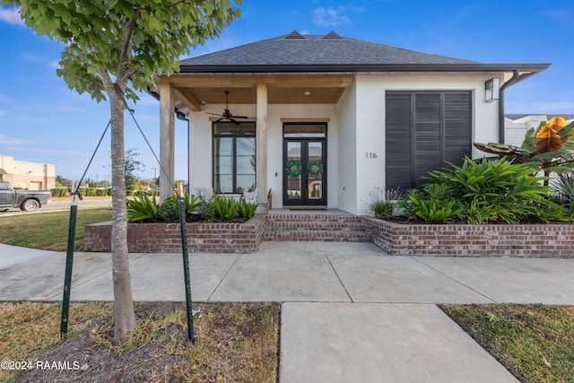 entrance to property featuring french doors and ceiling fan