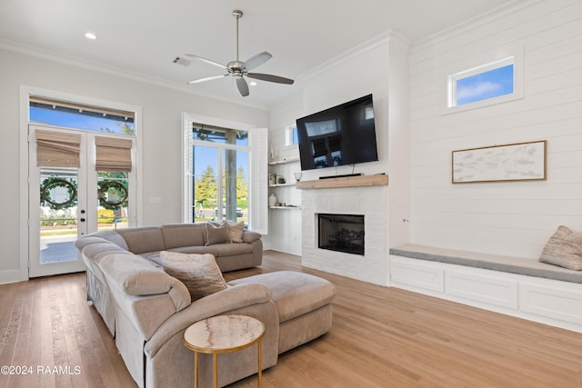 living room with crown molding, hardwood / wood-style floors, ceiling fan, and a wealth of natural light