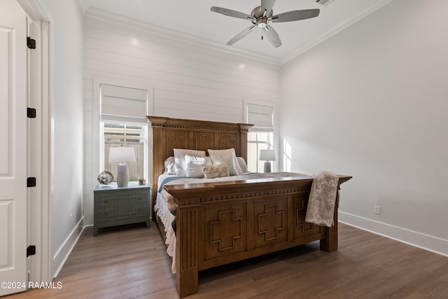 bedroom with ornamental molding, multiple windows, dark hardwood / wood-style floors, and ceiling fan