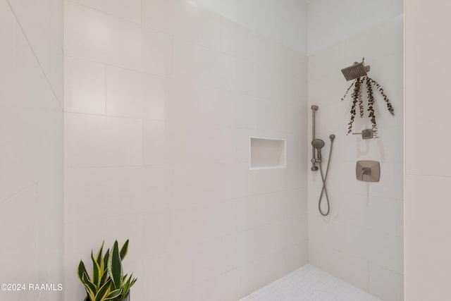 bathroom with a tile shower