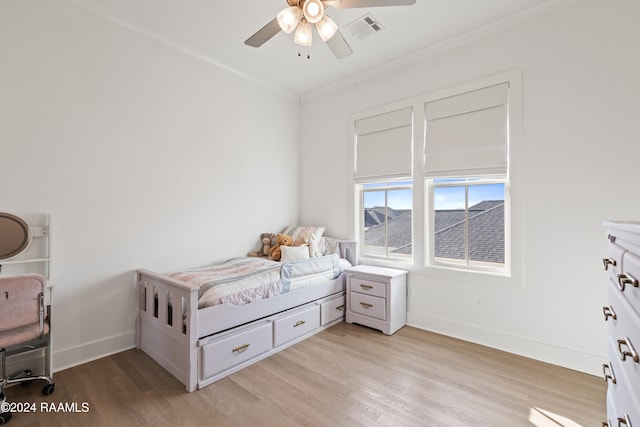 bedroom with light hardwood / wood-style floors and ceiling fan