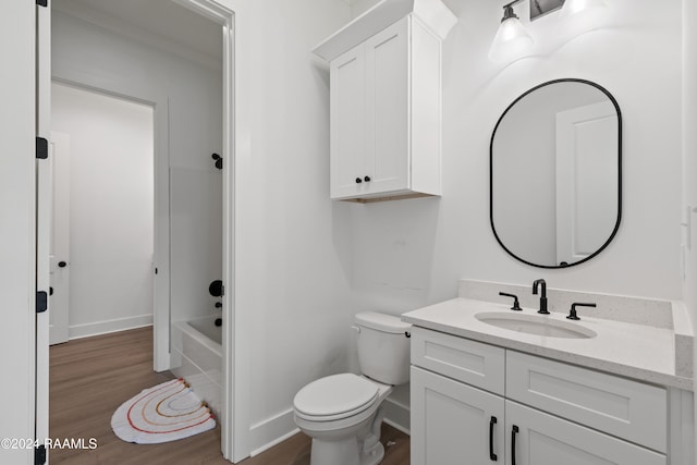 bathroom featuring toilet, hardwood / wood-style floors, and vanity