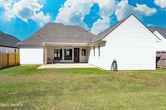 rear view of house featuring a patio area, a lawn, and ceiling fan