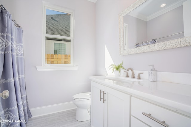 bathroom featuring vanity, crown molding, wood-type flooring, and toilet