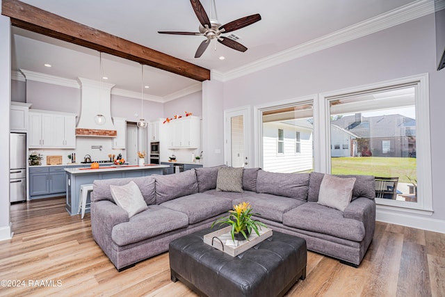 living room with light hardwood / wood-style floors, crown molding, beamed ceiling, and ceiling fan