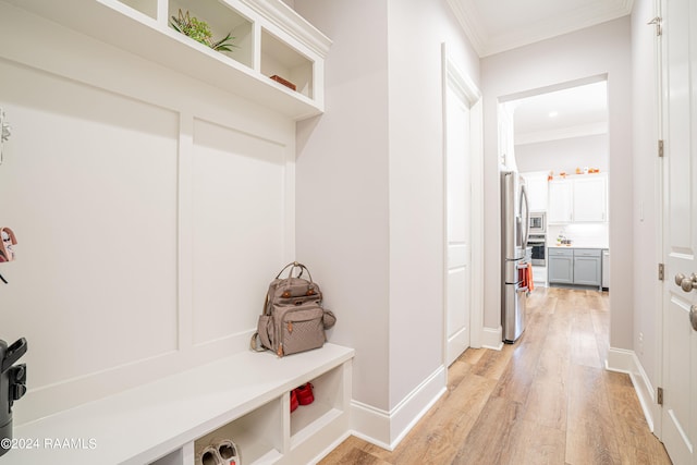 mudroom with crown molding and light wood-type flooring