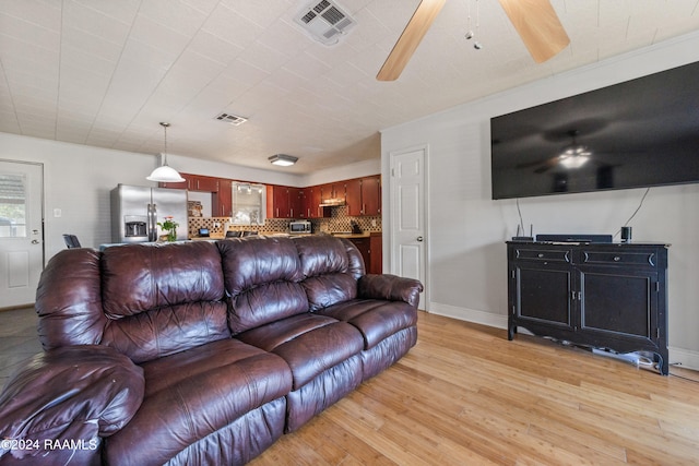 living room featuring light wood-type flooring and ceiling fan