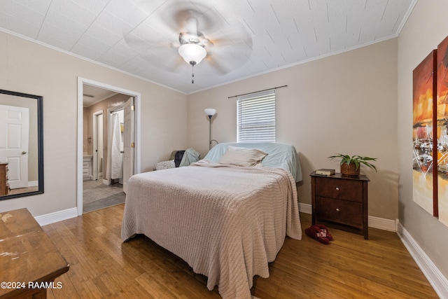 bedroom with ornamental molding, hardwood / wood-style flooring, and ceiling fan