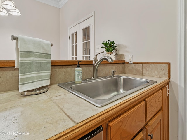 kitchen with sink, crown molding, and french doors