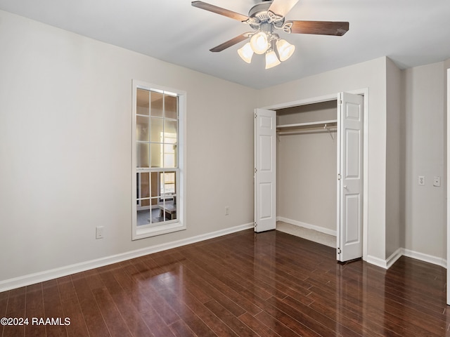 unfurnished bedroom with a closet, dark wood-type flooring, and ceiling fan