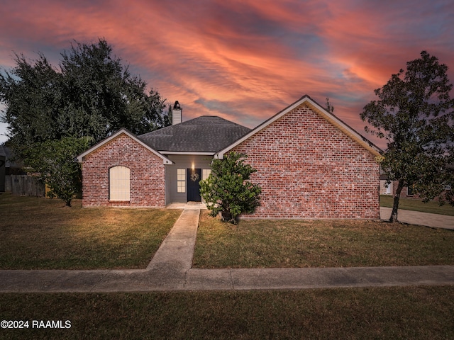 view of front of property with a yard