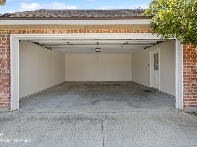 garage featuring a garage door opener and a carport