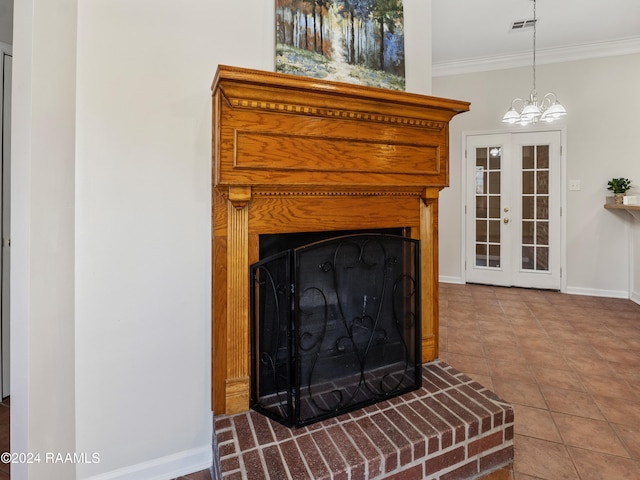 room details with french doors, tile patterned flooring, ornamental molding, an inviting chandelier, and a fireplace