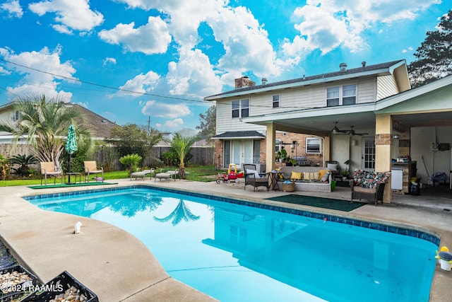 view of pool featuring a patio area, an outdoor living space, and ceiling fan