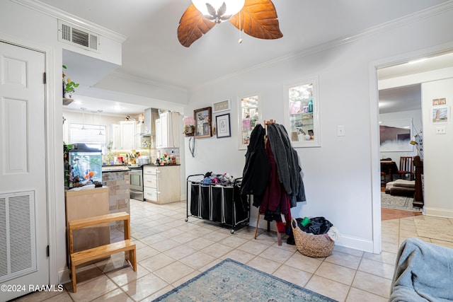 entrance foyer with crown molding, light tile patterned flooring, and ceiling fan