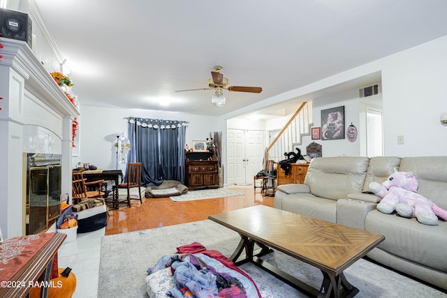 tiled living room with ceiling fan