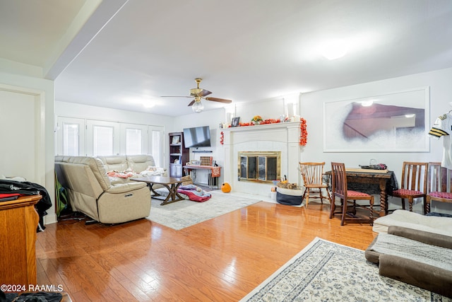 living room featuring ceiling fan and hardwood / wood-style floors