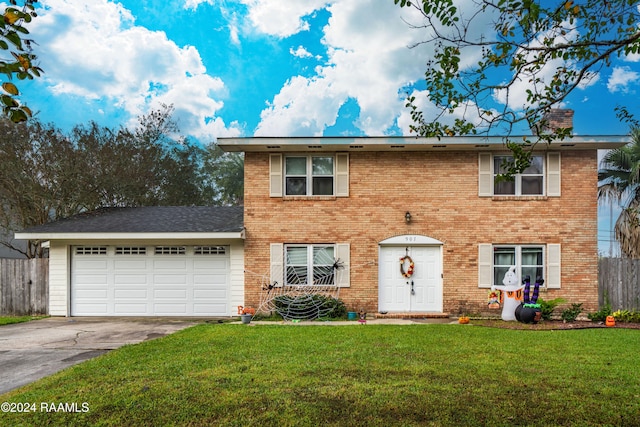 view of front of house with a garage and a front lawn