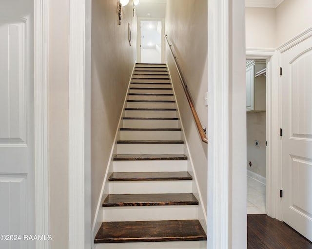 stairs featuring hardwood / wood-style floors