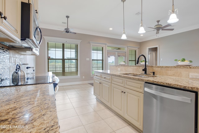 kitchen featuring stainless steel appliances, sink, light stone counters, ornamental molding, and cream cabinetry