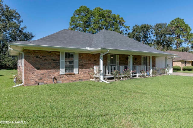 view of front of home with a front yard, a garage, and covered porch