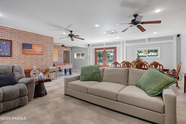 living area featuring a ceiling fan, brick wall, visible vents, and recessed lighting