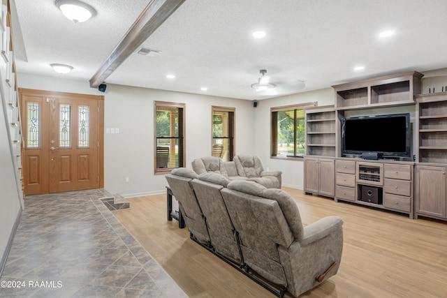 living area with visible vents, baseboards, recessed lighting, a textured ceiling, and light wood-style flooring