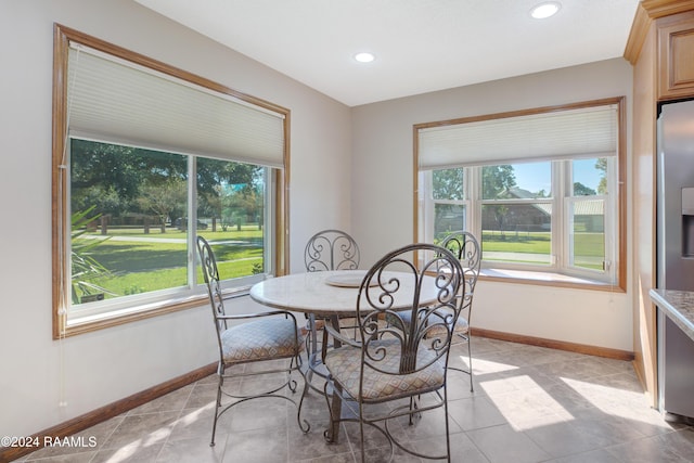 dining space with recessed lighting, baseboards, and light tile patterned floors