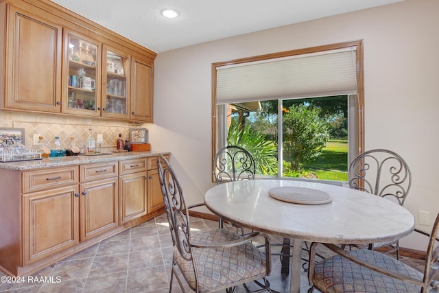 dining room featuring baseboards and recessed lighting