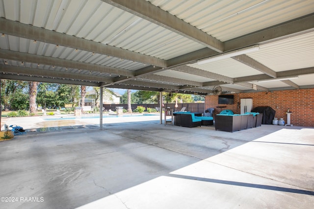 view of patio / terrace with an outdoor living space, fence, and a fenced in pool