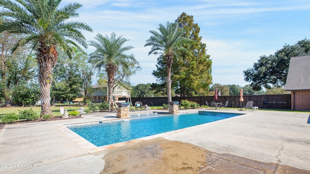 view of pool with fence, a fenced in pool, and a patio