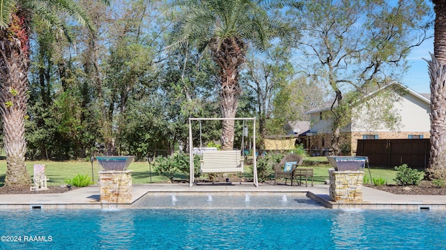 view of swimming pool featuring a fenced in pool, a lawn, fence, and a patio