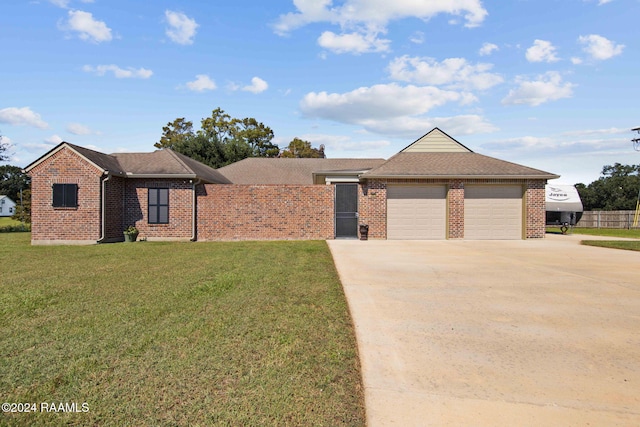 single story home with a front yard and a garage