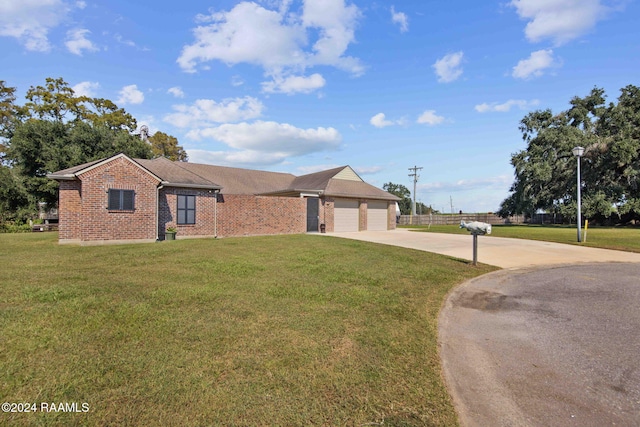 ranch-style home with a garage and a front lawn