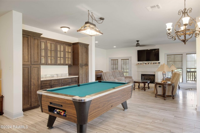 1053 Bayouside Ln, Parks, LA 70582 - rec room featuring billiards, visible vents, a fireplace, light wood-type flooring, and ceiling fan with notable chandelier