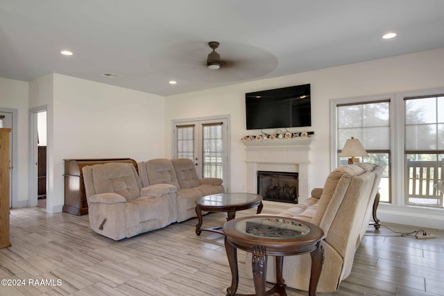 living room featuring a wealth of natural light, light hardwood / wood-style floors, and ceiling fan