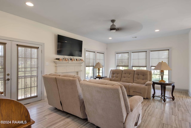 living room with french doors, light hardwood / wood-style floors, and ceiling fan