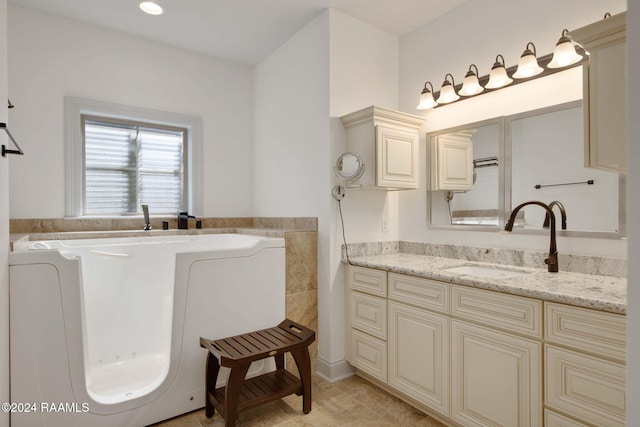 bathroom with vanity, tile patterned floors, and a washtub