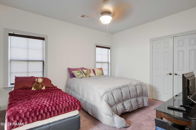 bedroom with a closet, ceiling fan, and carpet flooring