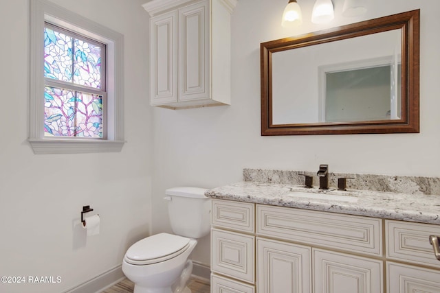 1053 Bayouside Ln, Parks, LA 70582 - half bathroom featuring vanity, baseboards, and toilet