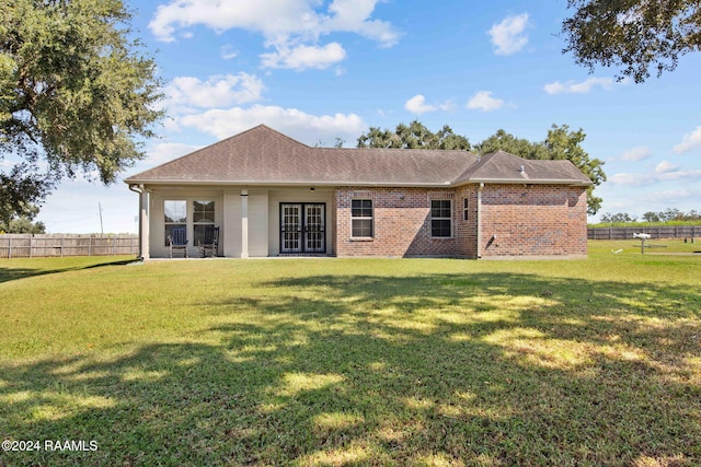 back of property featuring a lawn