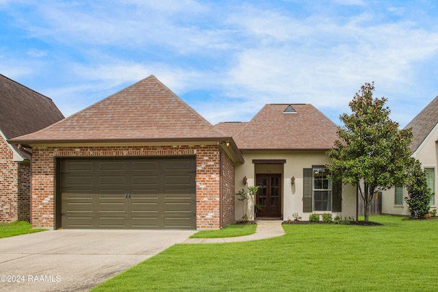 view of front of house with a front yard and a garage