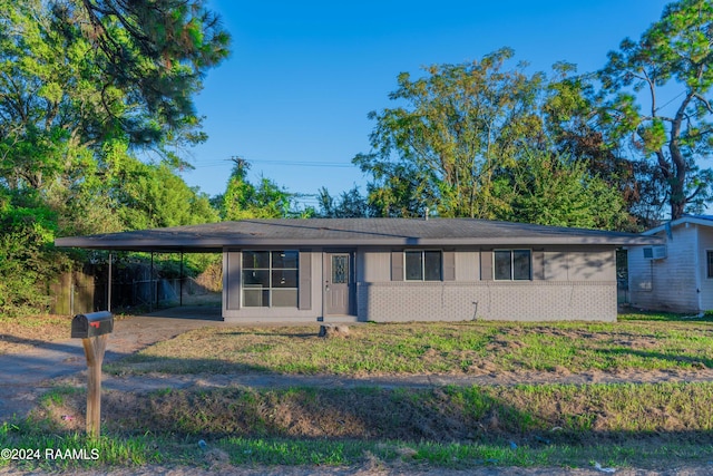 ranch-style home featuring a carport