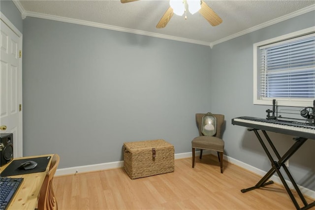 sitting room featuring ornamental molding, a ceiling fan, a textured ceiling, wood finished floors, and baseboards