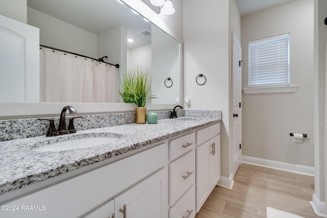 bathroom featuring hardwood / wood-style flooring and vanity