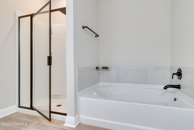 114 Rose Of Sharon Ln, Lafayette, LA 70508 - bathroom featuring a stall shower, a garden tub, and baseboards