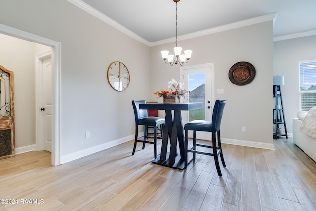 dining space featuring a notable chandelier, ornamental molding, and light hardwood / wood-style flooring