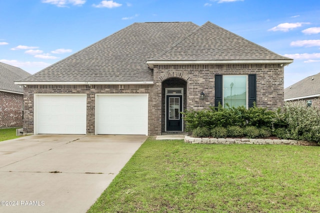 view of front of property with a garage and a front yard