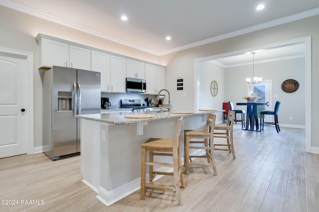 114 Rose Of Sharon Ln, Lafayette, LA 70508 - kitchen featuring stainless steel appliances, light wood-style flooring, a kitchen bar, a kitchen island with sink, and light stone counters