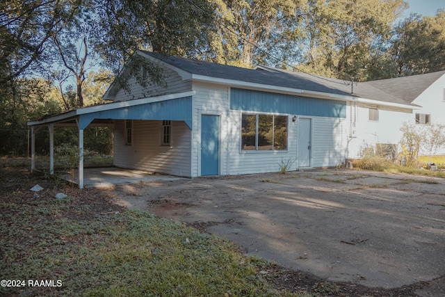 404 W Hickory St, Ville Platte, LA 70586 - view of side of home featuring concrete driveway and a carport